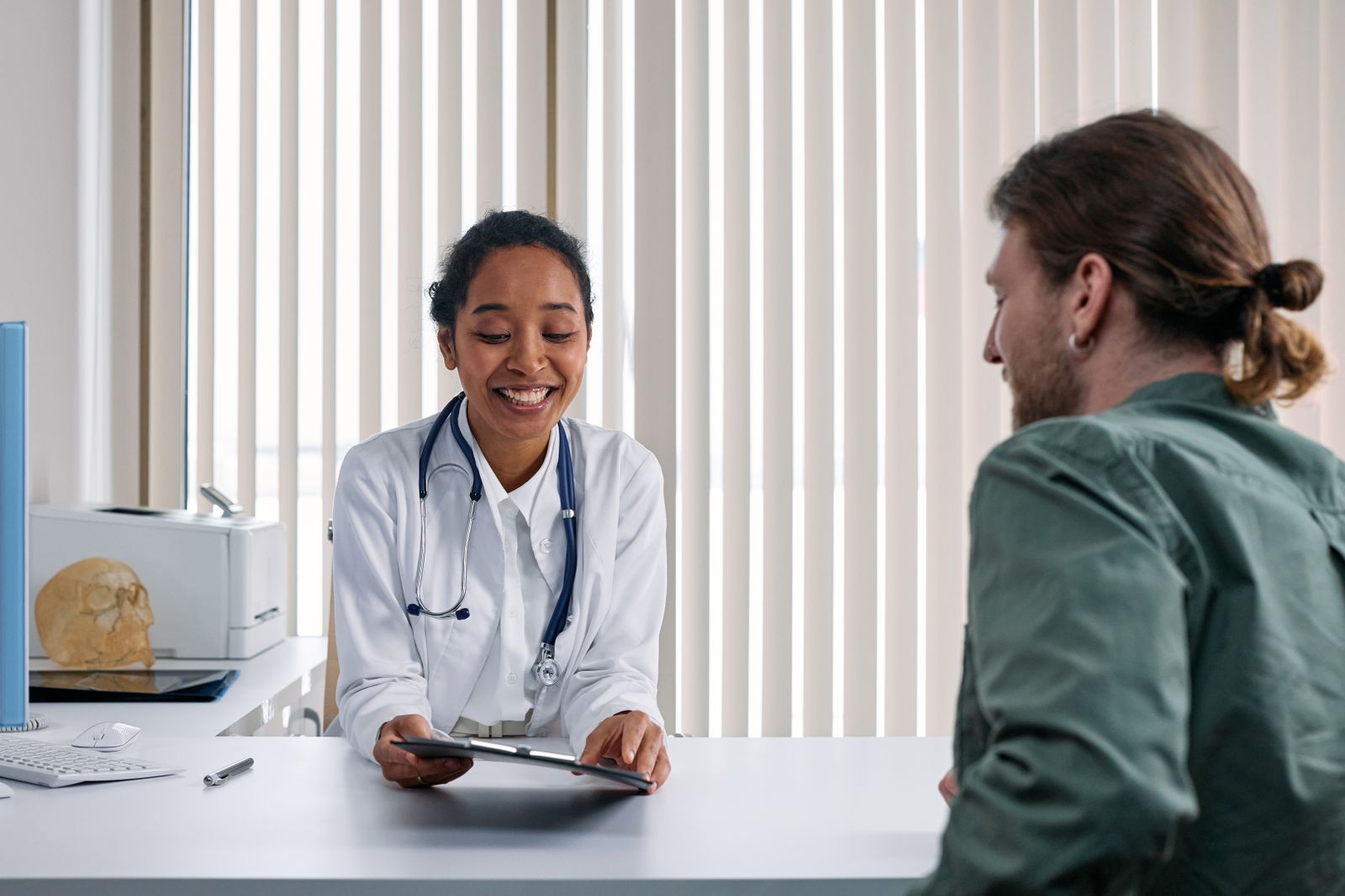 A healthcare professional meeting with a patient in a bright clinic